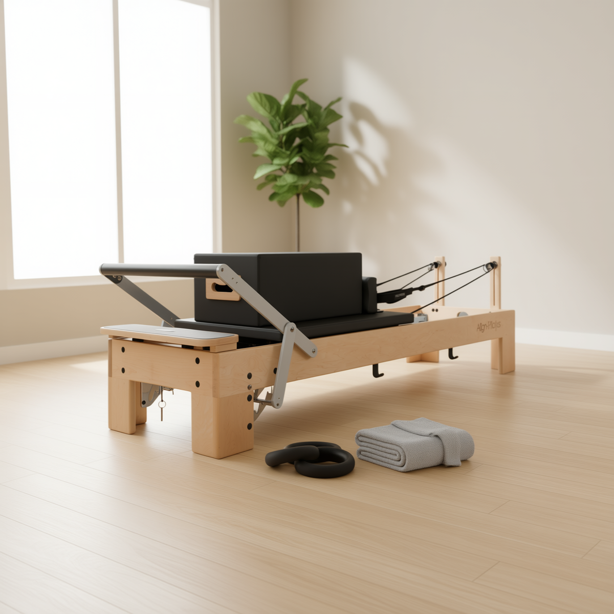 Align-Pilates M8-Pro Maple Wood Pilates Reformer with accessories in a bright studio with a plant