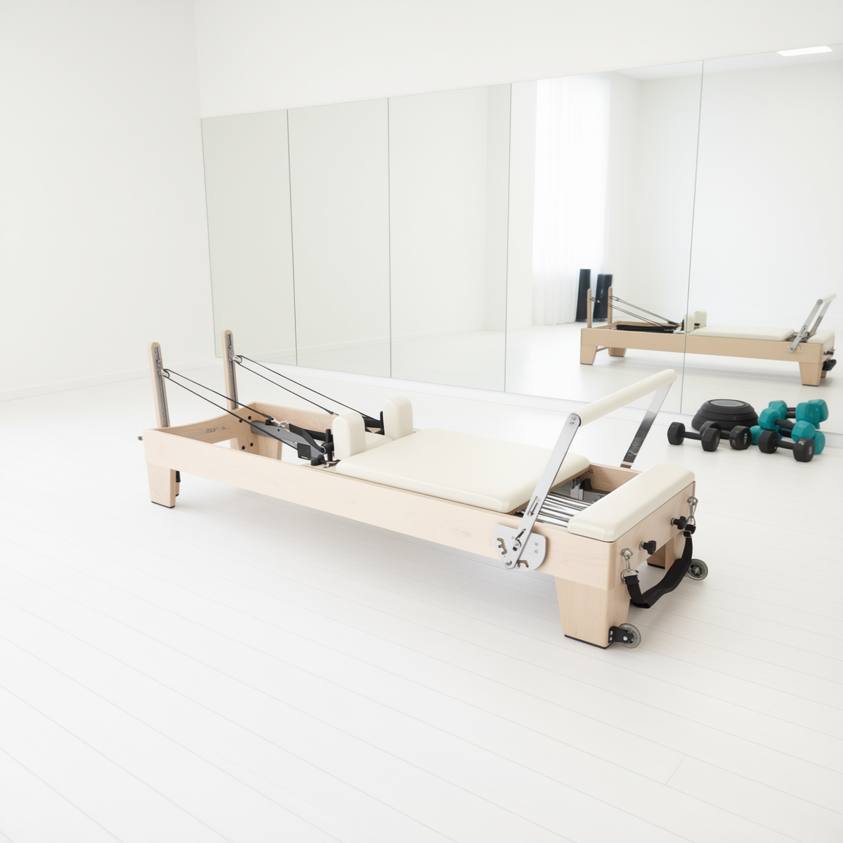 Elina Pilates Elite Reformer with cream upholstery in a bright white Pilates studio with mirrors