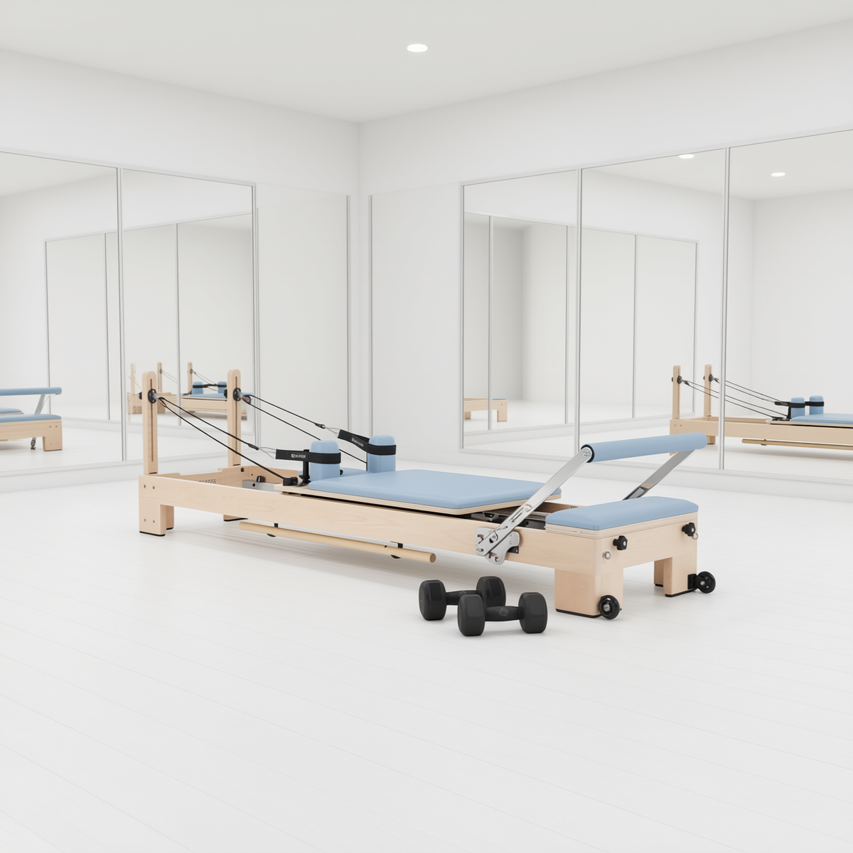 Elina Pilates Lignum Reformer with light blue upholstery in a white studio with mirrors and hand weights