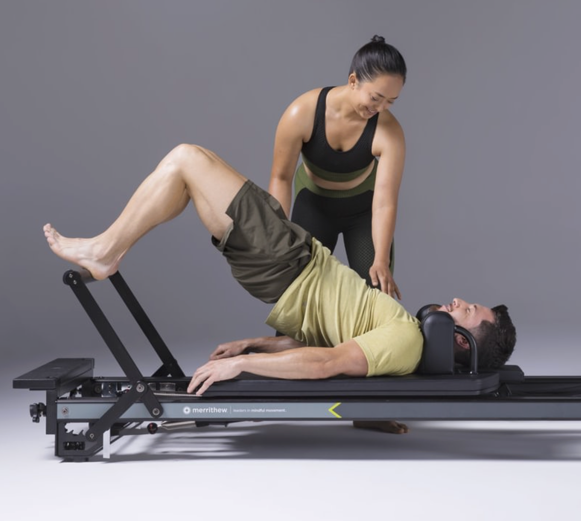 Instructor assisting a client on the Merrithew MPX Reformer Package