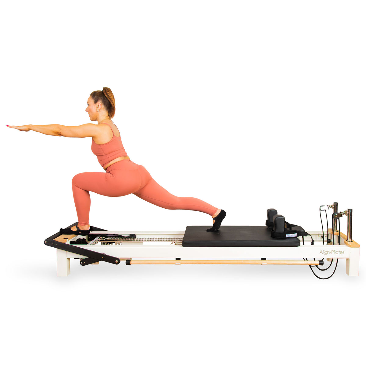 Woman using the Align-Pilates C8-S Pro Pilates reformer