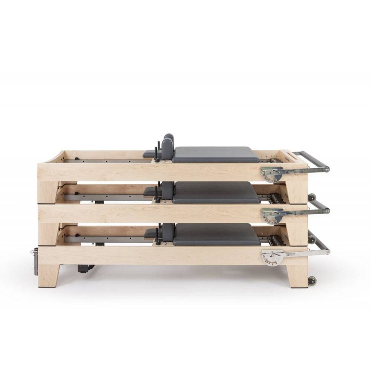 Three Elina Pilates Elite Reformers stacked together for compact studio storage