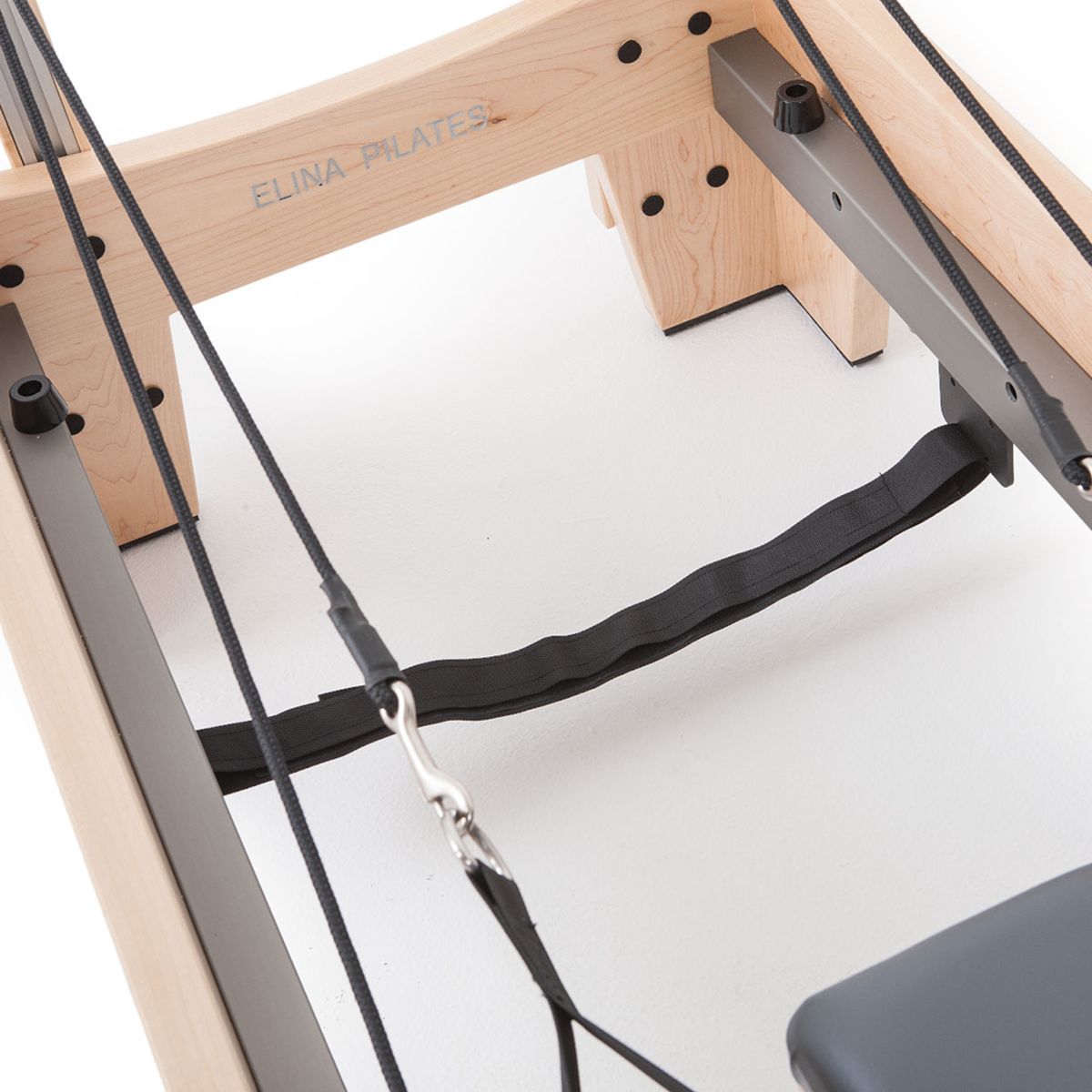 Detail of the wooden frame, ropes and padded strap on the Elina Pilates Elite Reformer