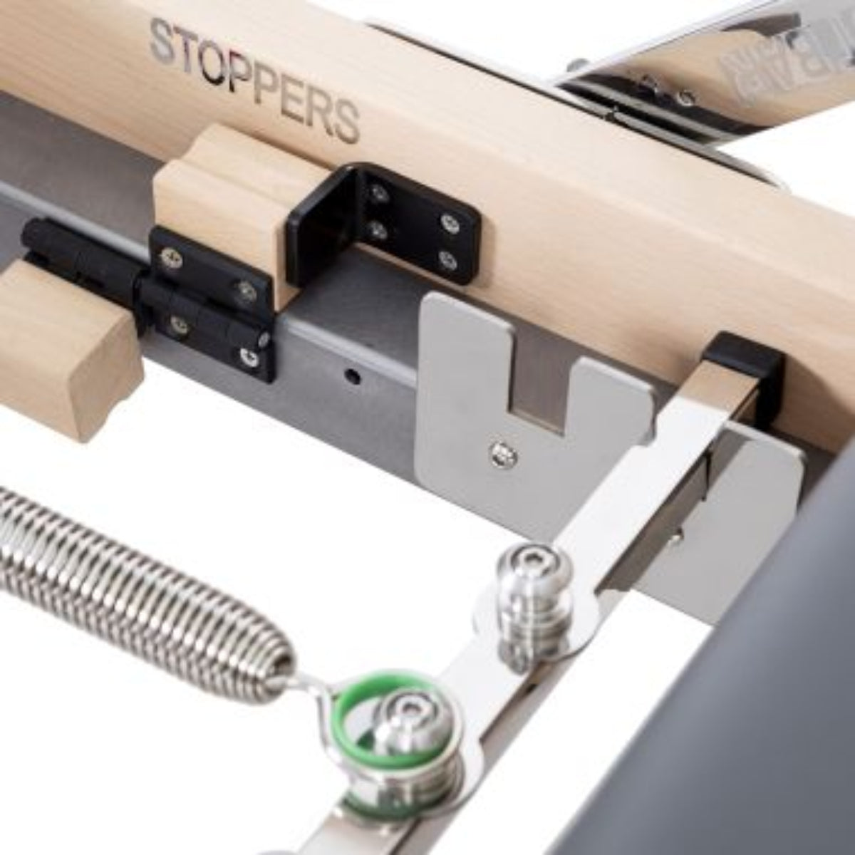 Close-up of a spring and carriage mechanism on the Elina Pilates Lignum Reformer