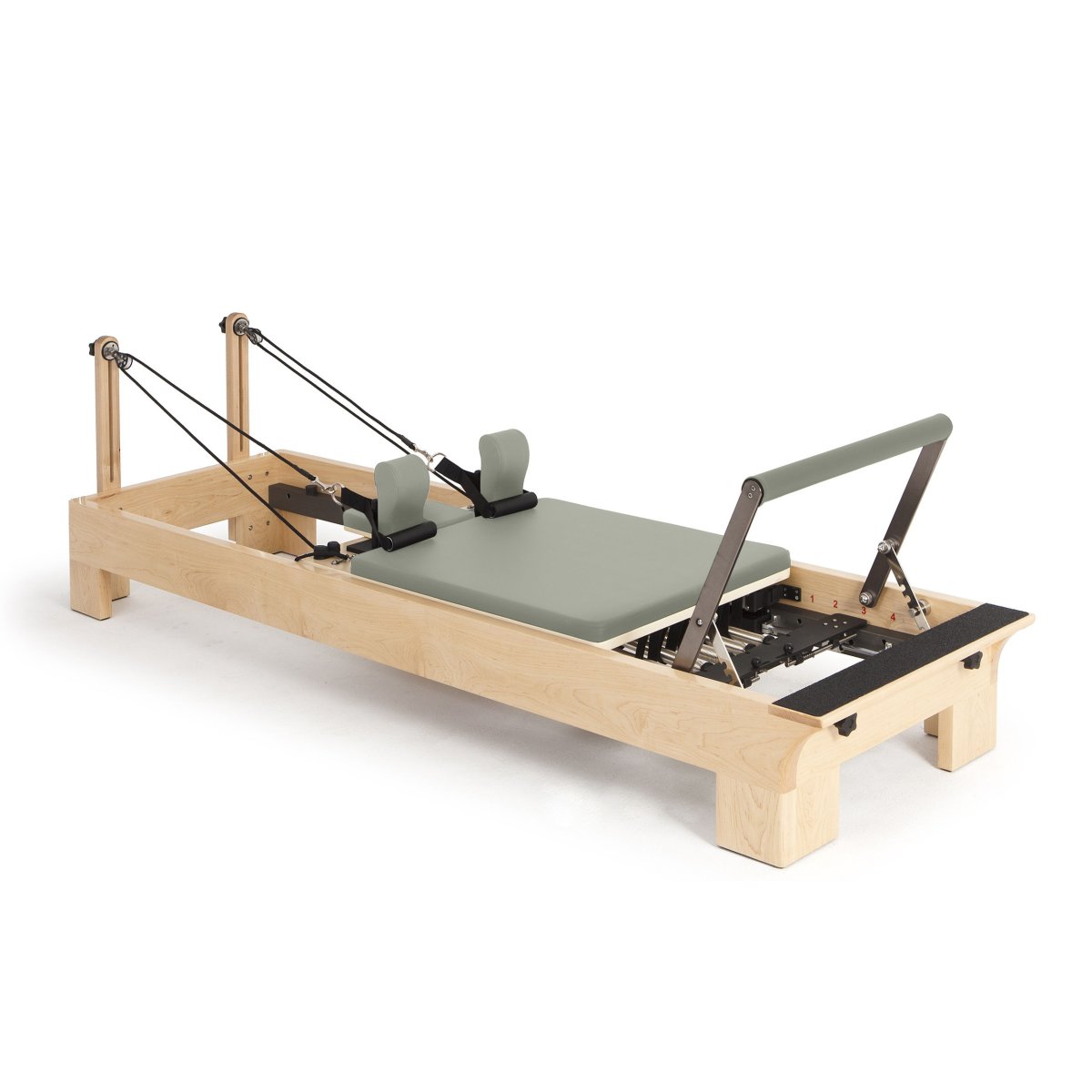 Elina Pilates Wooden Reformer with sage green upholstery, angled view on a white background